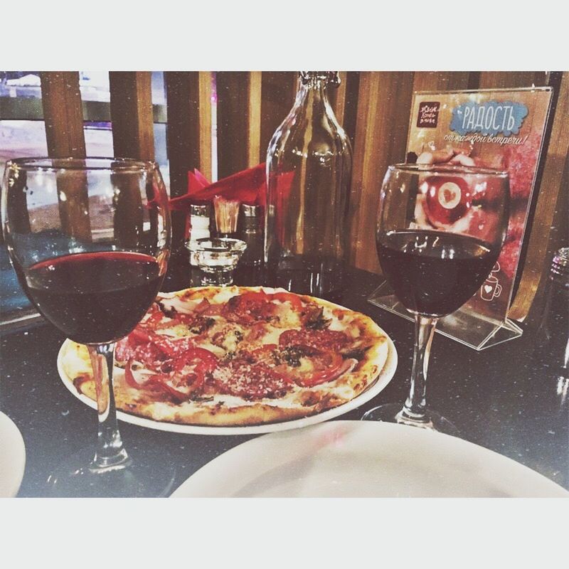 food and drink, pizza, wine, red wine, wineglass, wine bottle, food, alcohol, italian food, indoors, fork, table, meal, plate, no people, fast food, drink, freshness, close-up, day