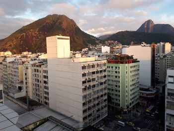 Buildings in city against cloudy sky