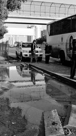 Cars on road against sky in city