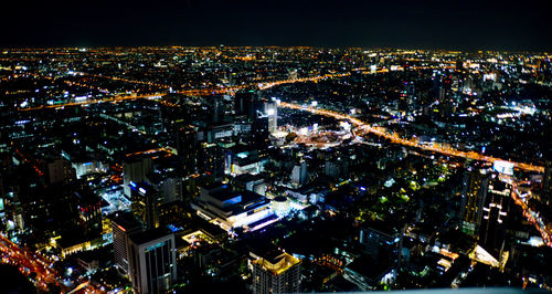 High angle view of illuminated city buildings at night