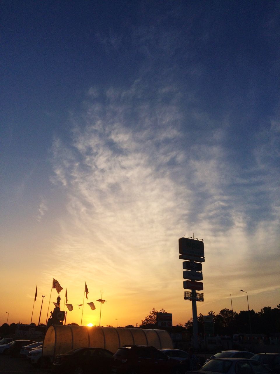 SILHOUETTE CRANES AGAINST SKY DURING SUNSET