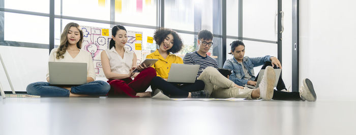 Group of people sitting in front of building