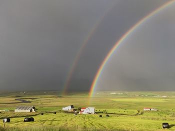 Scenic view of rainbow over agricultural field