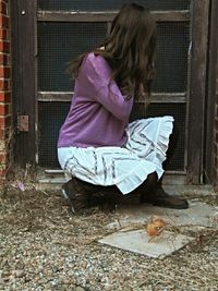 Full length of woman standing by railing