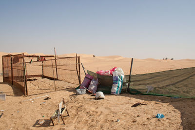 People working on desert against clear sky