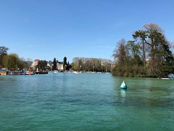 Scenic view of river against blue sky