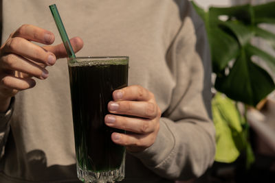 Midsection of man holding drink