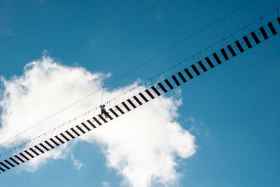 Low angle view of crane against sky