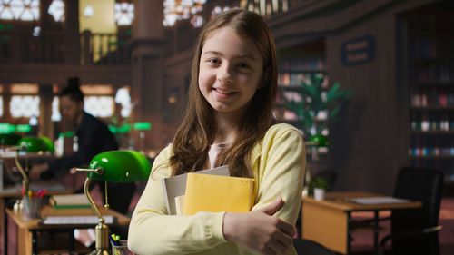 Portrait of young woman using mobile phone at cafe