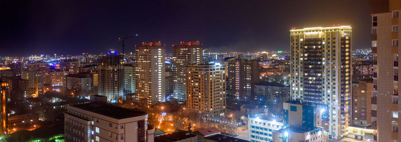 High angle view of illuminated buildings in city at night