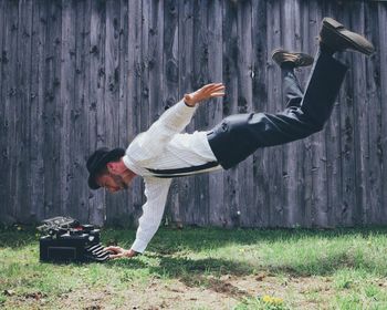 Man in mid-air typing on typewriter