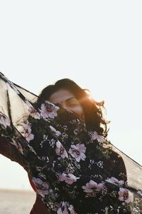 Portrait of woman with scarf against clear sky