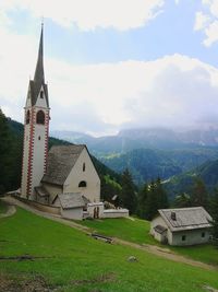 Traditional building by mountains against sky