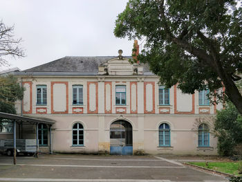 Building by road against sky