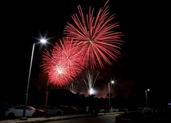 Low angle view of firework display at night