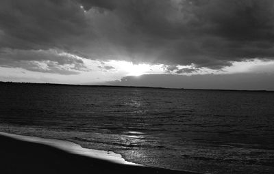 View of calm sea against cloudy sky