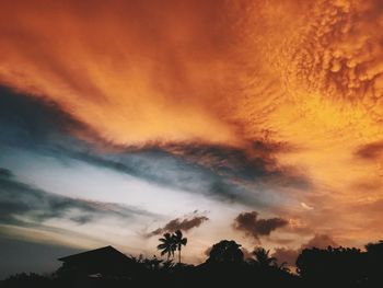 Low angle view of silhouette trees against romantic sky