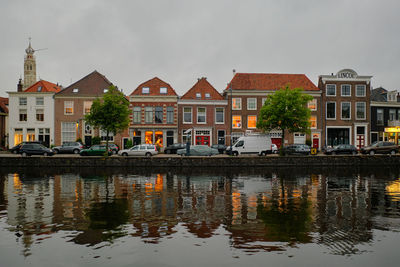 Haarlem, netherlands. panoramic view of traditional dutch houses in a row lining the river sparne.