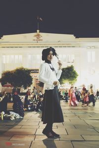 Woman standing on street in city