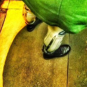 Low section of man standing on tiled floor