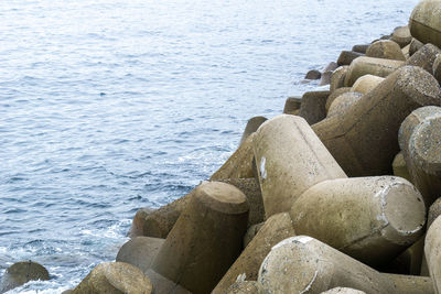 High angle view of rocks on sea shore