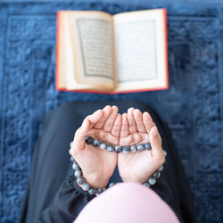 High angle view of hand holding book