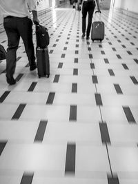 Low section of people walking on airport
