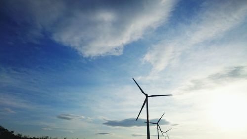 Low angle view of windmill against cloudy sky