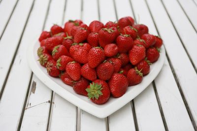 High angle view of strawberries in plate on table