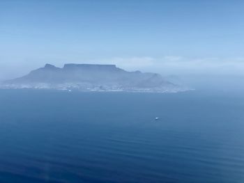 Scenic view of sea and mountains against sky