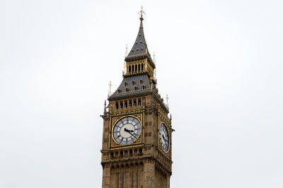 Low angle view of clock tower against clear sky