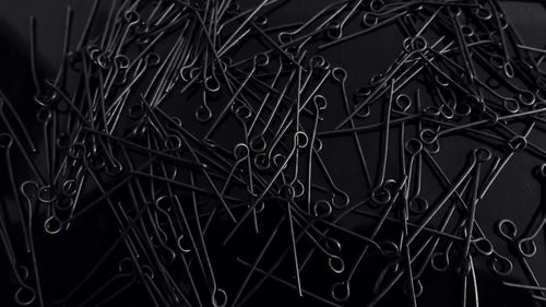 High angle view of metallic hooks on black background