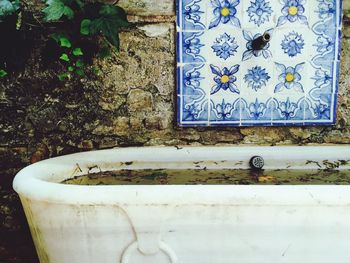 Close-up of bath tub against wall