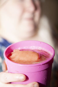 Close-up of hand holding coffee cup