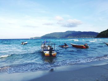 Boats on sea against sky