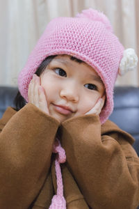 Close-up portrait of cute girl at home