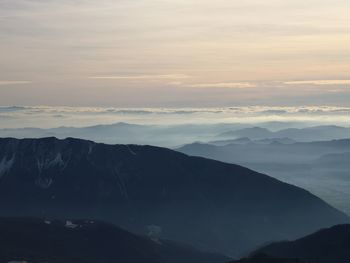 Scenic view of silhouette mountains against sky during sunset