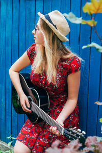 Midsection of woman wearing hat