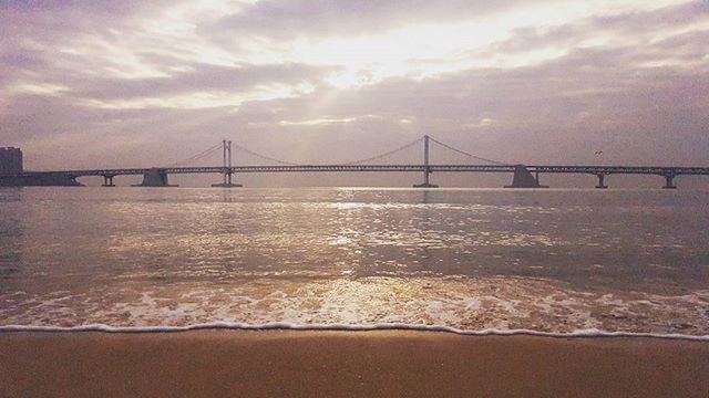 connection, bridge - man made structure, water, architecture, built structure, engineering, suspension bridge, sky, bridge, famous place, sea, travel destinations, river, international landmark, cloud - sky, golden gate bridge, tourism, transportation, travel, sunset