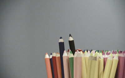 Close-up of colored pencils against white background