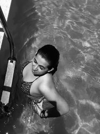 High angle view of woman standing in swimming pool