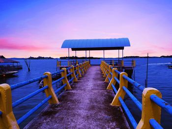 Pier against sky at sunset