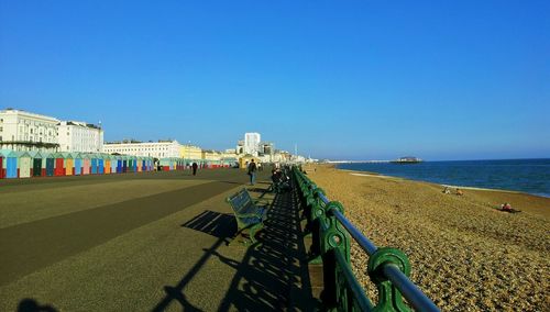 Scenic view of beach against clear blue sky