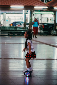 Full length of woman dancing on illuminated subway