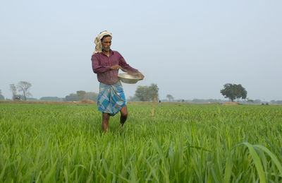 Full length of man standing in field