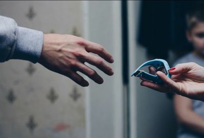 Close-up of hands holding camera