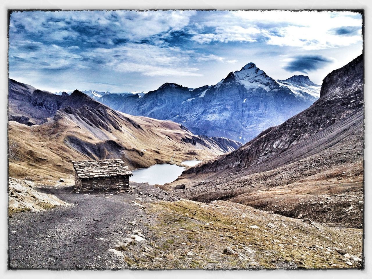 mountain, mountain range, sky, transfer print, tranquil scene, tranquility, scenics, cloud - sky, landscape, beauty in nature, nature, auto post production filter, rock - object, cloud, non-urban scene, cloudy, physical geography, rock formation, rocky mountains, remote