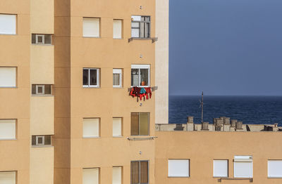 Building by sea against clear sky