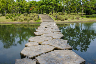 Stone wall by lake in park