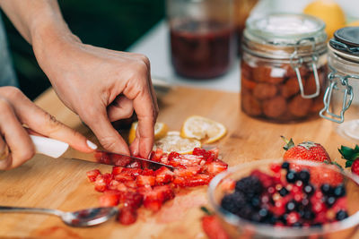 Cutting strawberries in the kitchen. fruit fermentation.